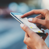 Mensch benutzt Handy mit Software von d.velop