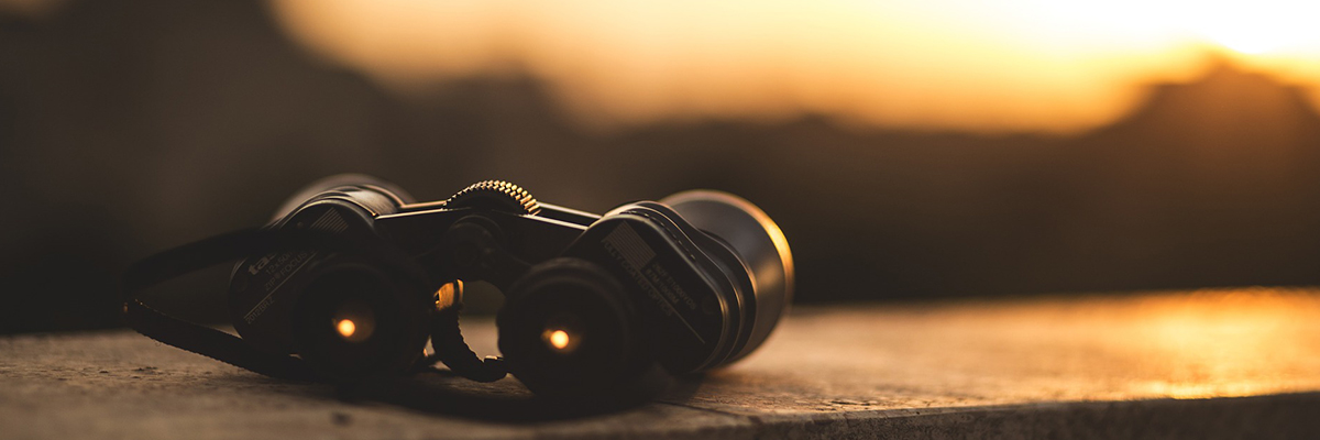 Fernglas und Sonnenuntergang